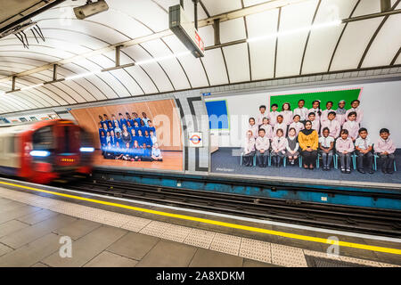 London, UK. 11th Nov 2019. Yr 3 project posters on the platform billboards at Pimlico underground station - Steve McQueen’s Year 3 project can now be seen as a large-scale installation at in the Duveen Galleries at Tate Britainon. It is also ovn 600 billboards across all 33 of London’s boroughs. The images feature class photos of Year 3 school children from London primary schools. Credit: Guy Bell/Alamy Live News Stock Photo