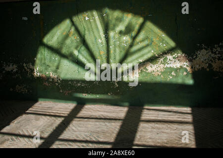 Shadows of wooden vintage frame on inside wall in sunny day Stock Photo