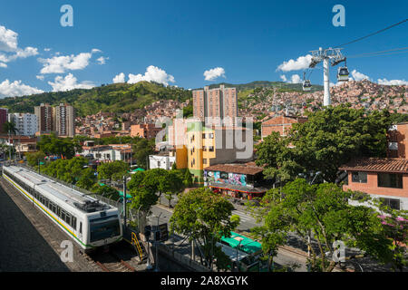San Javier metro station showing a train and the metrocable leading to comuna 7 in Medellin, Colombia. Stock Photo