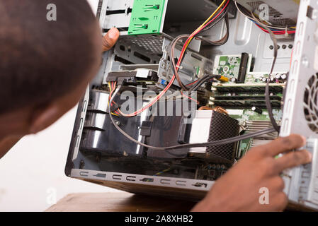 technician opens the computer hardware and verifies it. Stock Photo