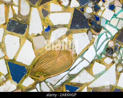 Background from multi-colored tiles on the wall. Pattern of broken tiles. pieces of tile on the wall. Stock Photo