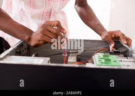 Close up of hands of a computer expert repairing a computer inside Stock Photo