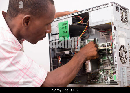 technician opens the computer hardware and verifies it. Stock Photo