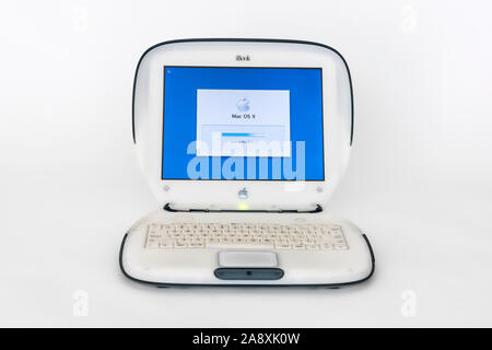 Los Angeles, California, USA - November 6, 2019:  Illustrative editorial photo of old Apple clamshell style iBook laptop computer with start up screen Stock Photo