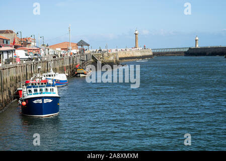 Fishing Boats and a Pirate Ship Tourist Boat Tied Up to the Whitby Quayside on the River Esk North Yorkshire England United Kingdom UK Stock Photo