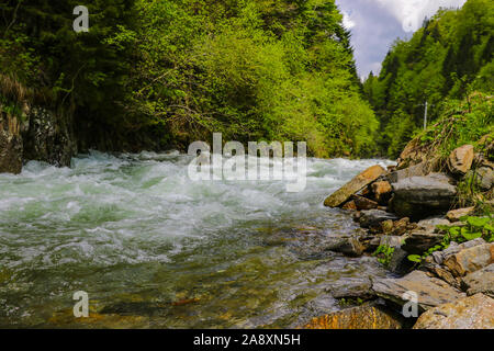 View of the fast mountain river high in the mountains along the Transfagaras road, Romania Stock Photo