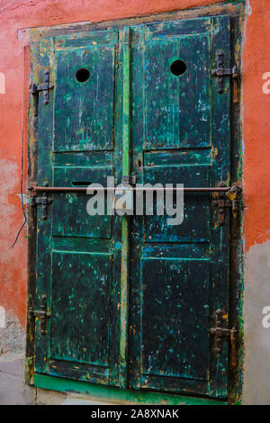 Sibiu, Romania, May 15, 2019: Traditional, colorful, decaying wooden courtyard doors of old townhouses in the center Stock Photo