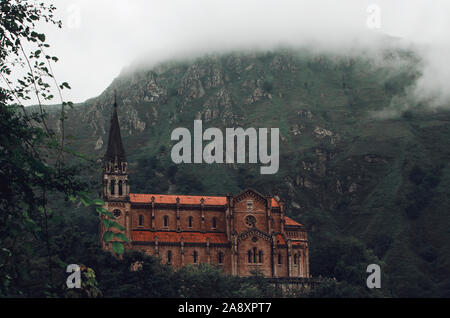 View of the Basilica of Our Lady of Battles on a foggy day, Covadonga, Asturias, Spain Stock Photo