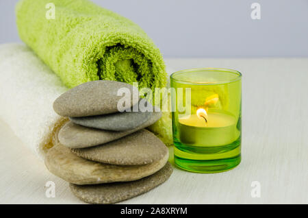 white and green towels and burning candle relax atmosphere Stock Photo