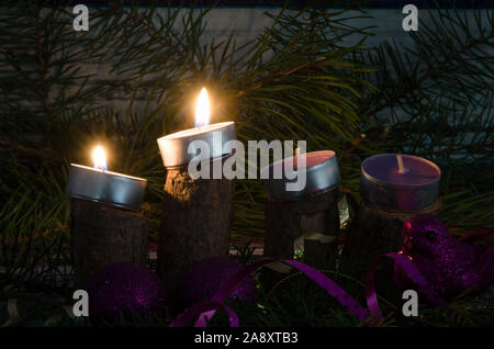 two from four advent candles burning Stock Photo
