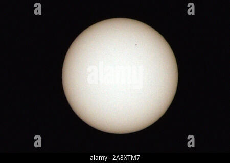 Las Vegas, Nevada, USA. 11th Nov, 2019. The planet Mercury is seen as a tiny dot in the upper right quadrant of the sun during a transit across the face of the sun, Monday, November 11, 2019, as seen from Las Vegas, Nevada. Mercury and Venus are the only planets that can appear to pass in front of, or transit, the sun as seen from Earth. The next transit by Mercury will not happen until 2032. Credit: David Becker/ZUMA Wire/Alamy Live News Stock Photo