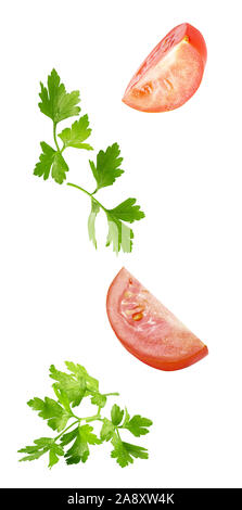 floating parsley and tomatoes isolated on white background Stock Photo