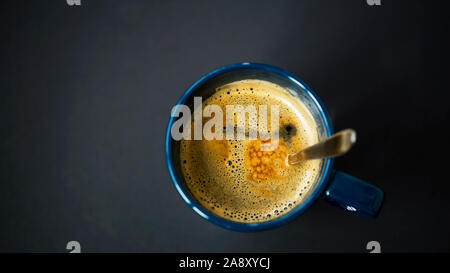 Espresso coffee cup top view with spoon on dark background Stock Photo