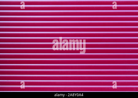 Closed red roller shutter for background or wallpaper Stock Photo
