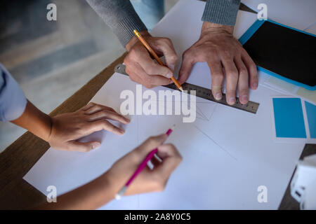 Top view of man and woman making sketches together Stock Photo