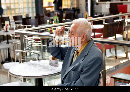 Well dressed older man on his own having a beer in cafe, Pula, Croatia Stock Photo