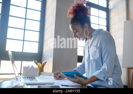 Young promising designer making sketches Stock Photo