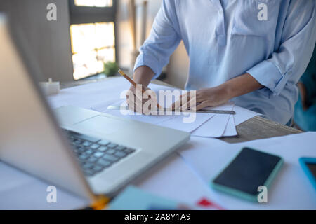 Close up of designer taking pencil while making sketches Stock Photo