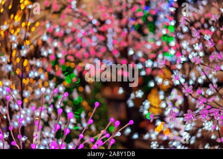 Defocused christmas background with multicolored lights. New Year's background with bokeh. Stock Photo