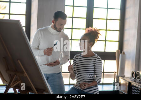 Professional artist giving master class for his friend Stock Photo