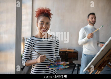 Artist feeling good enjoying cooperating with friend Stock Photo