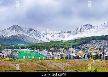 Panoramic view of the city of Ushuaia and the snowy Martial mountain range against a cloued sky. Stock Photo