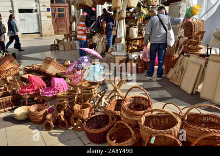 Market stall with display of wicker baskets, basketwork and other household items in central Pula, Croatia Stock Photo