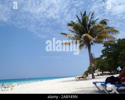 Varadero, Cuba - April, 30 2012: People relaxin along the beach on Varadero Peninsula, Matanzas Province, Cuba. Stock Photo