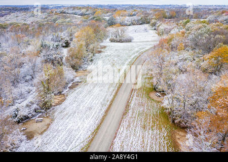 Forest and harvested corn field dusted by early snow, aerial view of Honey Creek Conservation Area in western Missouri Stock Photo