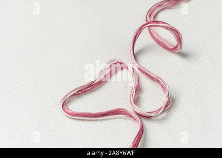 White canvas background with colorful threads. Embroidery concept. Mockup for hobby. Stock Photo