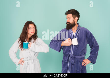 family life and routine. couple has problems in relationship. warm up our relations. tea time at home. morning couple drink coffee. woman and hipster man coffee cup. hard morning. Again in bad mood. Stock Photo