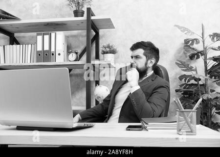 Responding on business e-mail. Brutal businessman in office. Mature man with beard work on laptop. bearded hipster use computer. Male boss working. Keeping business on top with digital technologies. Stock Photo