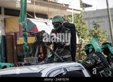 Palestinian Hamas militants take part during an anti-Israel military show in the southern Gaza Strip.Izz el-Deen al-Qassam Brigades, the armed wing of Palestinian resistance movement Hamas, hold an anti-Israel military show in the southern Gaza Strip as part of the anniversary of the prevention of Israeli covert operation carried out in the Khan Younis on 11 November 2018. Stock Photo