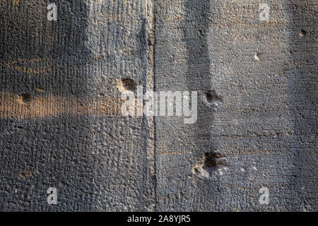 Close-up of bullet holes and shrapnel damage from the Second World War, on the exterior of St. Lorenz Kirche in the historic city of Nuremberg, German Stock Photo