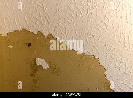 Ceiling damage in need of repair.  Home repair needed for damaged peeling plaster. Stock Photo