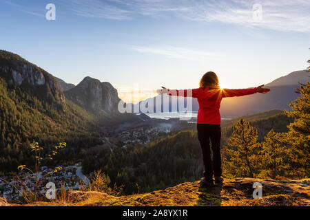 Adventurous Girl Hiking in the mountains during a sunny Autumn Sunset. Taken Squamish, North of Vancouver, British Columbia, Canada. Concept: Adventur Stock Photo