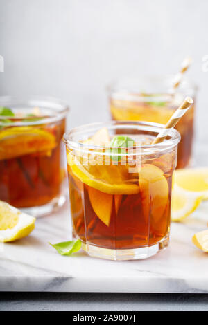 Peach and lemon sweet iced tea on a marble surface Stock Photo