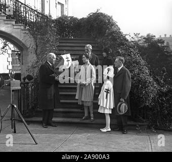 Mrs. Coolidge is presented with original ship model for the 1928 Xmas seals. The original ship model for the 1928 Christmas seals being presented to Mrs. Calvin Coolidge at the White House today by Dr. Kendall Emerson, managinng director of the National Tuberculosis Association. Stock Photo