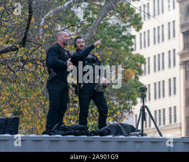 New York, NY - November 11, 2019: Members of Secret Service observe area during President Donald J. Trump and First Lady Melania Trump attending Veterans Day Parade's opening ceremony at Madison Square Park Stock Photo