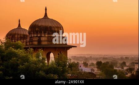 Traditional north Indian palace domes in low light, almost silhouetted against the beautiful dawn sky, in Mandawa, Rajasthan, India. Stock Photo