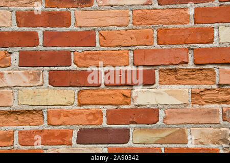 Brick wall in shades of orange, red, and cream Stock Photo