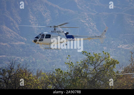 Sylmar, CA / USA - Nov. 9, 2019: A U.S. Customs and Border Protection helicopter, operated by the Dept. of Homeland Security, is shown flying low. Stock Photo