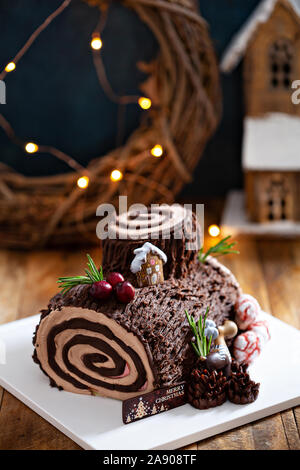 Christmas Yule log cake with edible sweet mushrooms and pine cones Stock Photo
