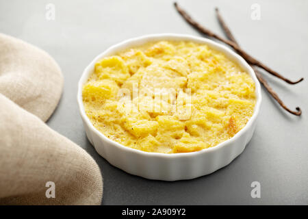 Vanilla custard bread pudding in a white ramekin Stock Photo