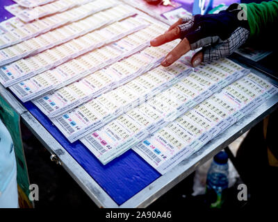 SEPTEMBER 28, 2019 : Bangkok, Thailand : Working class people choosing Thai government lottery from lottery store. Stock Photo