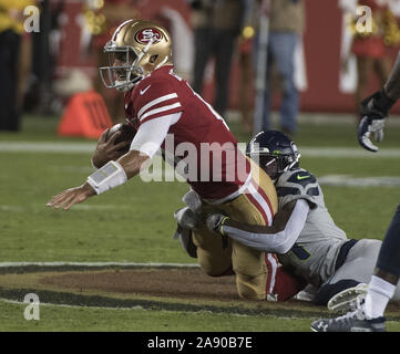 Santa Clara, California, USA . 11th Nov, 2019. San Francisco 49ers quarterback Jimmy Garoppolo (10) is sacked by the Seattle Seahawks in the first quarter at Levi's Stadium in Santa  Clara, California on Monday, November 11, 2019. The Seahawks defreated the 49ers 27-24 in overtime.    Photo by Terry Schmitt/UPI Credit: UPI/Alamy Live News Stock Photo