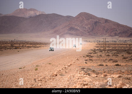 4WD cars of self-drive tourist driving on the C-14 gravel road in Namibia Stock Photo