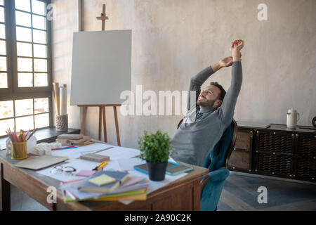 Cheerful man feeling satisfied after finishing new project Stock Photo