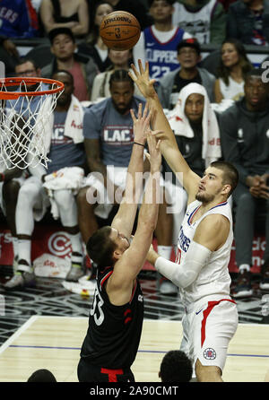 Los Angeles, California, USA. 11th Nov, 2019. Los Angeles Clippers' Ivica Zubac (40) shoots against Toronto Raptors' Marc Gasol (33) during an NBA basketball game between Los Angeles Clippers and Toronto Raptors, Monday, November 11, 2019, in Los Angeles. Credit: Ringo Chiu/ZUMA Wire/Alamy Live News Stock Photo