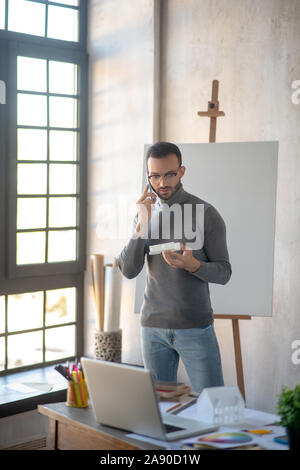 Interior designer calling client while having questions Stock Photo